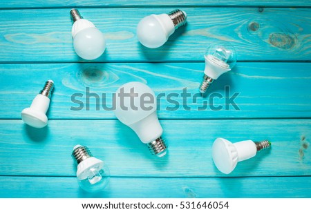 Set of different row LED bulbs on blue wood background