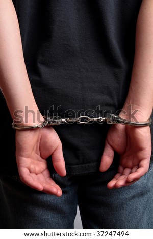 stock photo A man is handcuffed behind his back