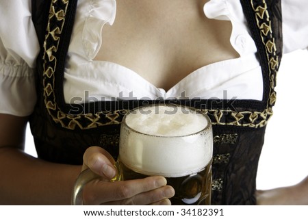 Bavarian beer girl holds Oktoberfest beer stein in front of breast