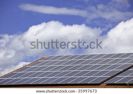 Solar cell panels on a roof on a cloudy and nice day
