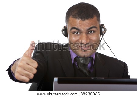 Call center agent wearing a headset and expressing happiness by showing thumb up.