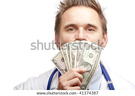 Closeup of doctor kissing a bundle of us dollar bills. Isolated on white.