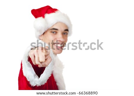 Smiling male teenager dressed as santa claus points with finger. Isolated on white background.