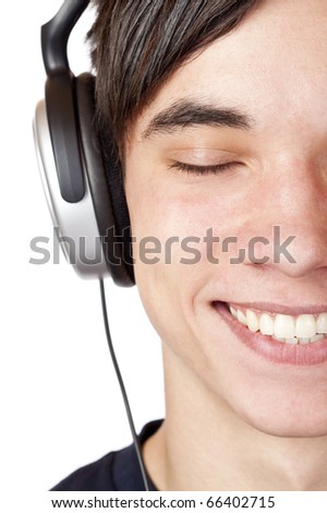 Close-up macro of a male teenager listening to music with headphone. Isolated on white.