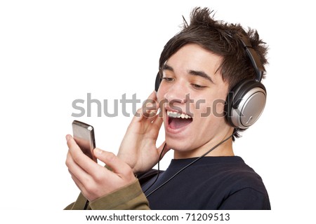 stock photo Male Teenager with headphones listening to music and sings 