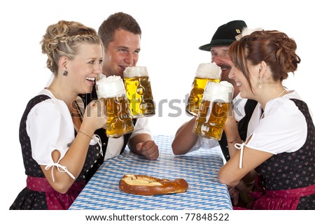 Bavarian men and women drink cheerfully Oktoberfest beer stein. Isolated on white background.