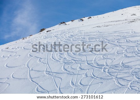 traces of the skis on the snow, traces of snowboarding on the snow-covered slope
