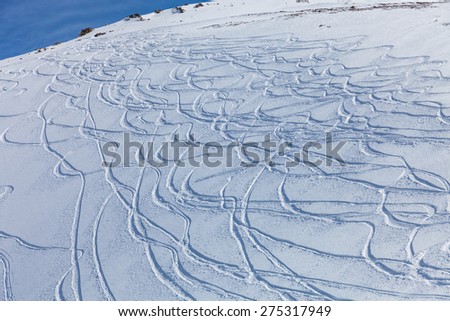 traces of the skis on the snow, traces of snowboarding on the snow-covered slope