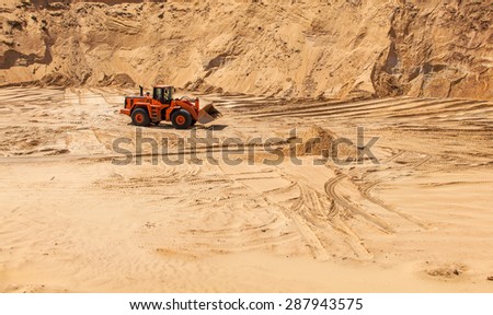 The excavator works in the sandy quarry, sand mining, sand pit