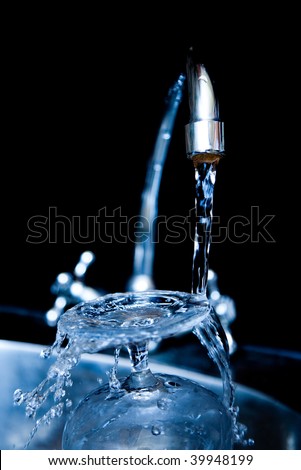 Water dripping from water faucet, closeup