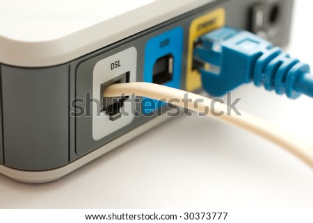 Broadband modem with telephone cable plugged in and blue ethernet cable in the background