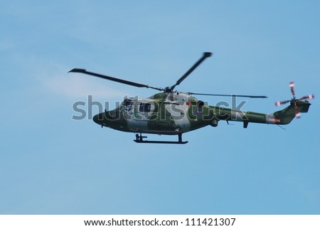 EASTBOURNE, ENGLAND - AUGUST 11: A Westland Lynx AH.7 multi purpose helicopter of the Army Air Corps performs at the Airbourne airshow on August 11, 2012 at Eastbourne, East Sussex.
