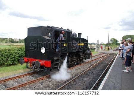 BODIAM, ENGLAND - AUGUST 20: USA 0-6-0T class steam locomotive on the Kent and East Sussex Railway on August 20, 2012 at Bodiam, Sussex. Built in the USA in 1943, it is now in Southern Railway livery.