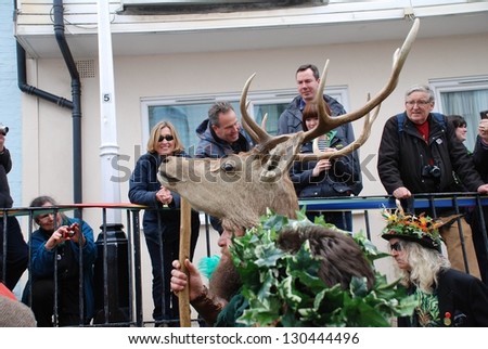 HASTINGS, ENGLAND - MAY 7: A man wearing a deer head takes parts in a parade through the Old Town during the annual Jack In The Green festival on May 7, 2012 in Hastings, East Sussex.