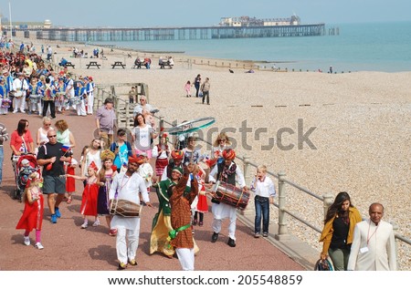 ST.LEONARDS-ON-SEA, ENGLAND - JULY 12, 2014: The Musifar Gypsies of Rajasthan, Indian music group, lead the parade on the seafront at the annual St.Leonards Festival. The event was first held in 2006.
