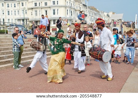ST.LEONARDS-ON-SEA, ENGLAND - JULY 12, 2014: The Musifar Gypsies of Rajasthan, Indian music group, lead the parade on the seafront at the annual St.Leonards Festival. The event was first held in 2006.