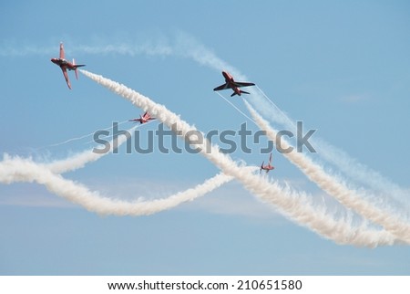 EASTBOURNE, ENGLAND - AUGUST 15, 2013: RAF aerobatic team The Red Arrows perform at the annual free Airbourne airshow at Eastbourne in East Sussex. The team were formed in 1965.