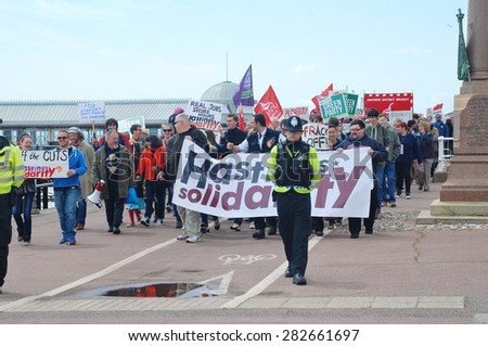 HASTINGS, ENGLAND - MAY 30, 2015: Protestors take part in a march along the seafront to demonstrate against austerity measures and Government cutbacks after the Conservatives won the General Election.