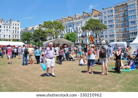 ST. LEONARDS-ON-SEA, ENGLAND - JULY 11, 2015: People enjoy the annual St.Leonards Festival held in Warrior Square Gardens. The free community music and entertainment event was first held in 2006.
