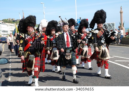 HASTINGS, ENGLAND-APRIL 26: The 1066 Pipes and Drums Band lead a St.George's Day parade on April 26, 2009 along the seafront at Hastings, East Sussex.
