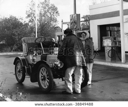HORLEY, ENGLAND-NOVEMBER 6: A  car stops at a garage during the London-Brighton Veteran Car Run on November 6, 1977 in Horley, Surrey. The 86k run is the worlds longest running motoring event.
