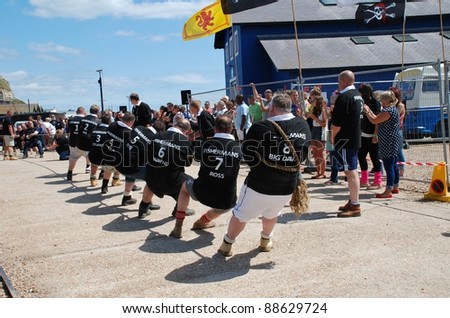 HASTINGS, ENGLAND - JULY 30: Local pub teams compete in a Tug of War match during the Old Town Carnival on July 30, 2011 in Hastings, East Sussex, England. Until 1920 the sport was part of the Olympic Games.
