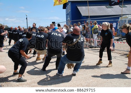 HASTINGS, ENGLAND - JULY 30: Local pub teams compete in a Tug of War match during the Old Town Carnival on July 30, 2011 in Hastings, East Sussex, England. Until 1920 the sport was part of the Olympic Games.