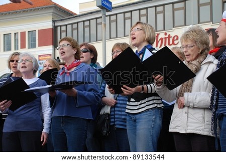 HASTINGS, ENGLAND - MARCH 12: The Sound Waves Community Choir perform at a fund raising event on March 12, 2011 at Hastings, East Sussex, England. The choir was formed in Hastings in 2009.