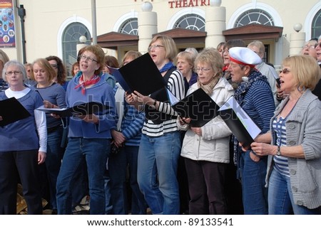HASTINGS, ENGLAND - MARCH 12: The Sound Waves Community Choir perform at a fund raising event on March 12, 2011 at Hastings, East Sussex, England. The choir was formed in Hastings in 2009.