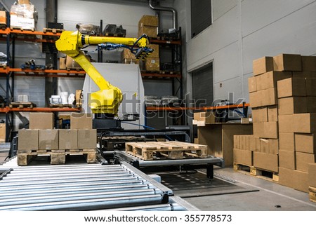 KAUNAS, LITHUANIA - DECEMBER 22, 2015: Robot arm which can lift boxes. Robotic industry