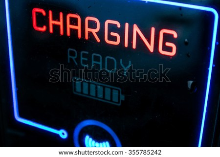 KAUNAS, LITHUANIA - DECEMBER 22, 2015: Electric vehicle charging point. LCD screen of charging