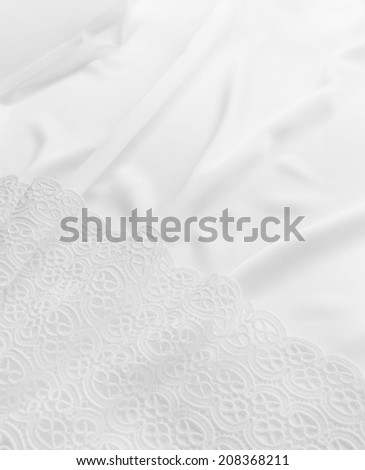Smooth elegant white silk background. Elegant white background with lace and silk