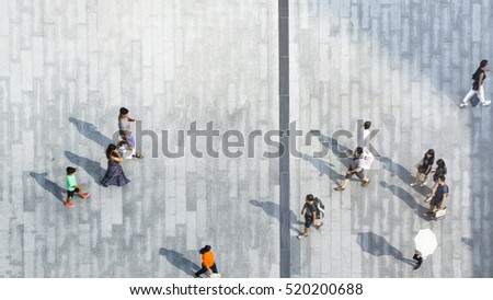 People walk on pathway concrete landscape of top view city street with silhouette shadow on the ground
