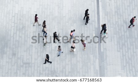 people walk on the pedestrian city street walkway on pavement concrete with the teenage young boy and girl and the group of fashion man and woman. (Aerial urban city photo)