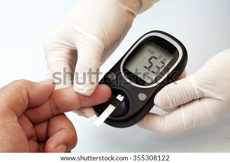 measuring glucose level with a digital glucose meter. concept of diabetics checking level sugar.