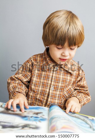 Smiling child reading a book