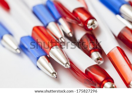 blue and red pens on white