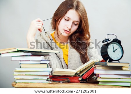 funny crazy  girl student with glasses reading books