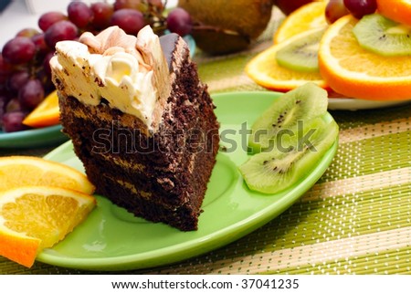 Birthday cake with cream with fruit in the background