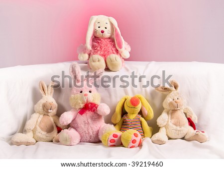 five toy rabbits on a pink background