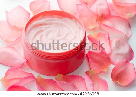 cosmetic cream surrounded by rose petals