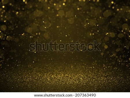 Highlighted bokeh gold sparkle glitter background. Defocused glitter stars background