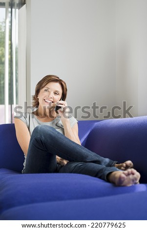 Portrait of a mature woman making a telephone call in a relaxed mode