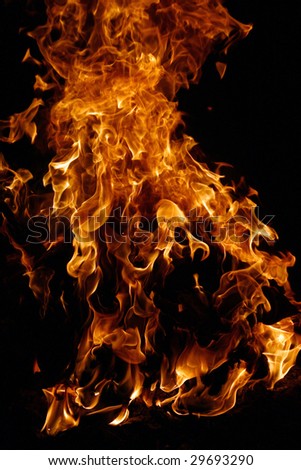 Stock photo of  storming blusterous  bright fire dancing on a dark background