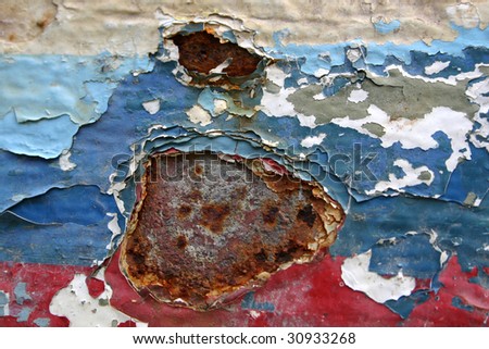 An abstract picture of eroded cracked old paint on metal surface on board