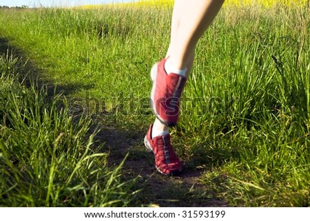An image of woman\'s feet running on the road