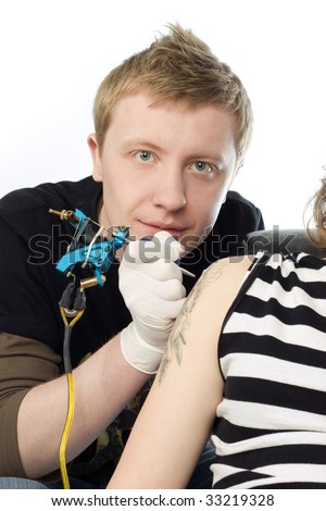 A man making procedure of tattoo on 