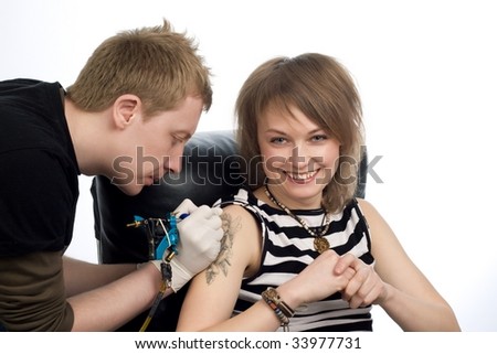 Stock Photo A Man Drawing Tattoo Picture On Womans Arm
