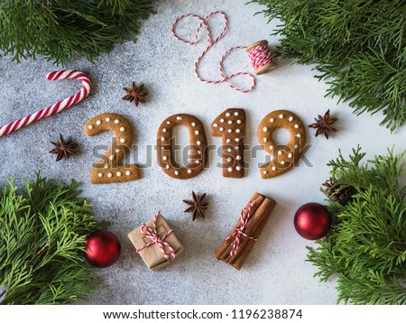 Ginger biscuits of the form of numbers and 2019 new year ginger cookies on grey background. Top view. Seasonal packaging and New Year\'s attributes