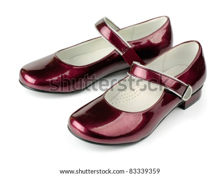 Red girls patent leather shoes isolated on white